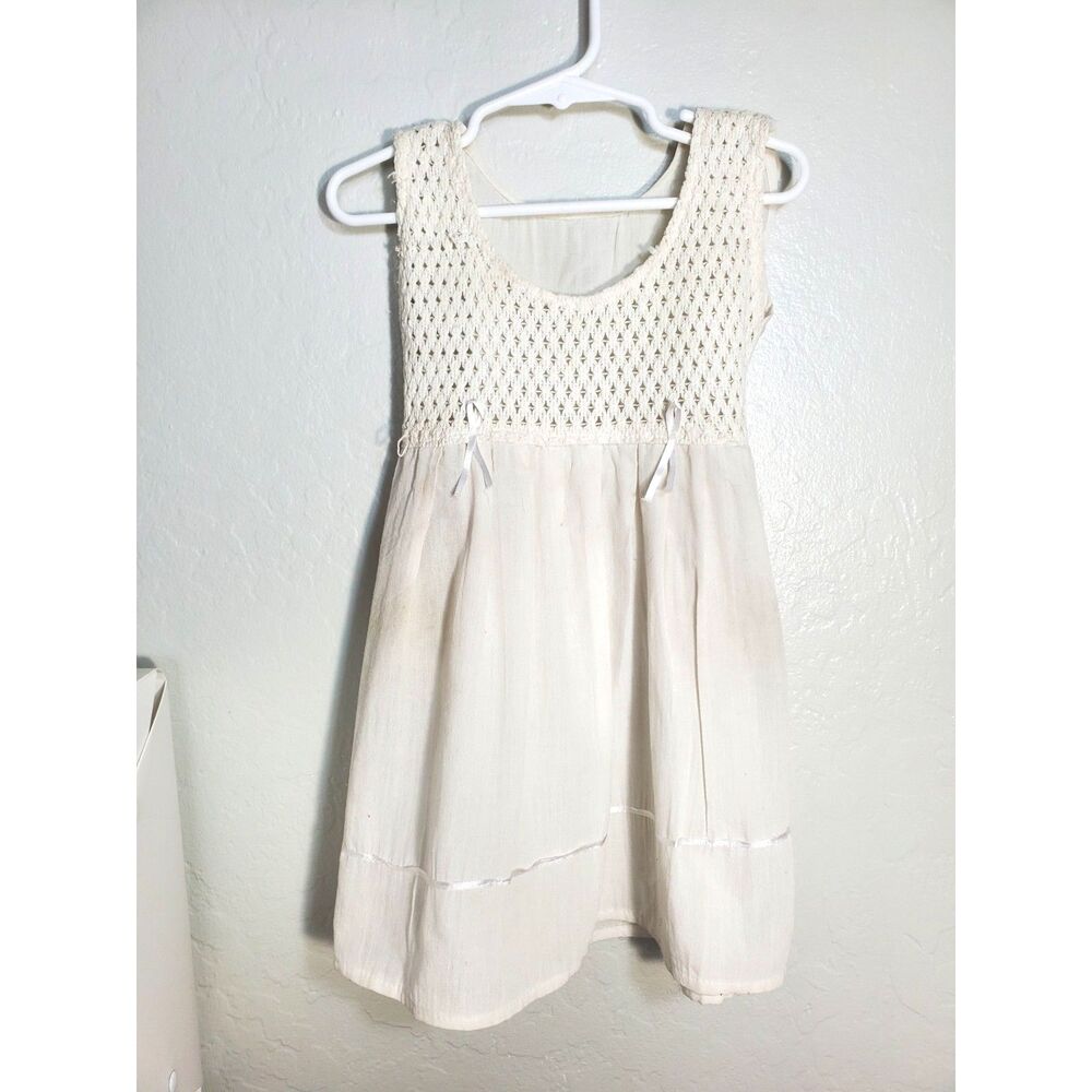Toddlers off white dress with Satin lace bows and around the bottom by the hem